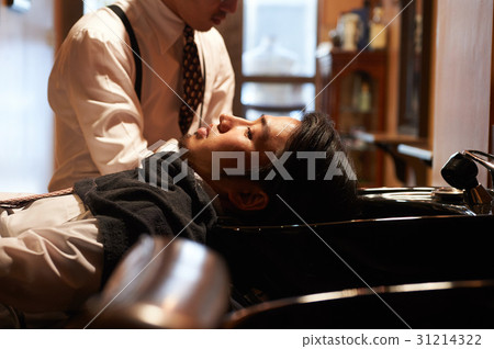 Shaving hairdresser shaving male guest 31214322