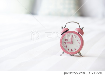 Alarm clock on the bed and time to wake up Alarm clock on the bed and time to wake up 31215591