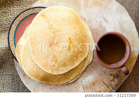 Several yellow crepes with cup of tea Several yellow crepes with cup of tea 31217269