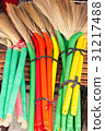 heap of bright brooms on market 31217488