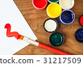 watercolors and brushes on wooden background 31217509