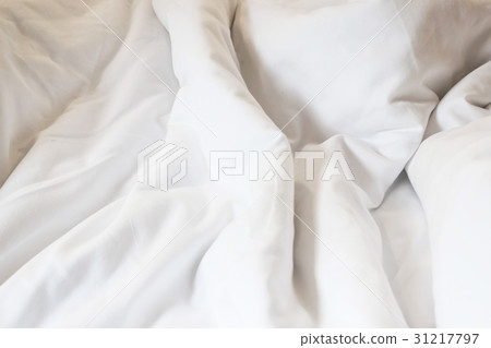 white pillow on bed and with wrinkle messy blanket 31217797