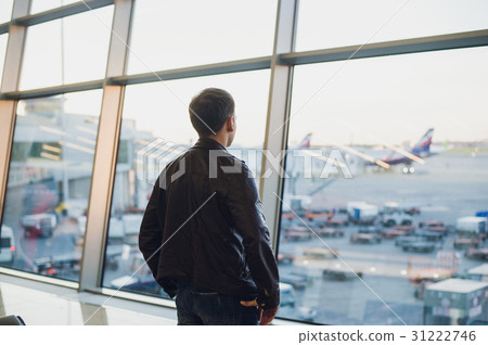 Travel concept with young man in airport interior 31222746