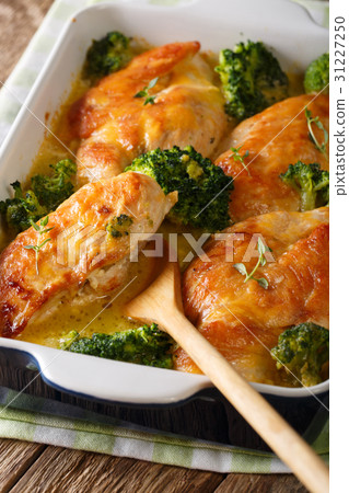 Tasty chicken fillet and broccoli baked in cheese Tasty chicken fillet and broccoli baked in cheese 31227250