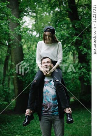 couple fulling around , plaing in the park 31227315