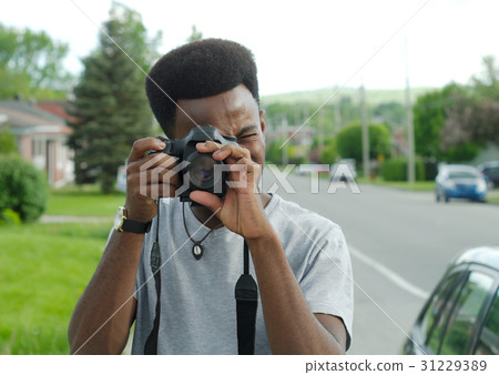 young man photographer camera outside photo shoot young man photographer camera outside photo shoot 31229389