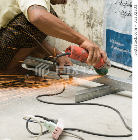 WORKER CUTTING STEEL WITH ELECTRIC WHEEL GRINDER WORKER CUTTING STEEL WITH ELECTRIC WHEEL GRINDER 31232833
