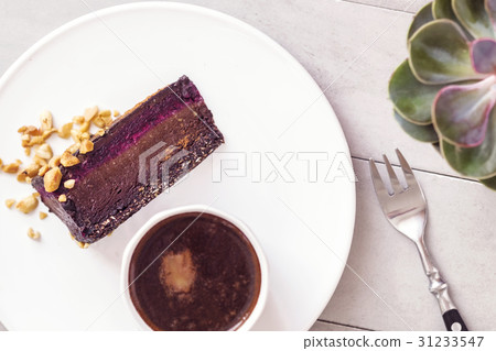 Hot coffee and slice of raw chocolate cake Hot coffee and slice of raw chocolate cake 31233547