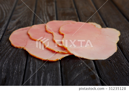 slices of fresh ham on wooden table. slices of fresh ham on wooden table. 31235128