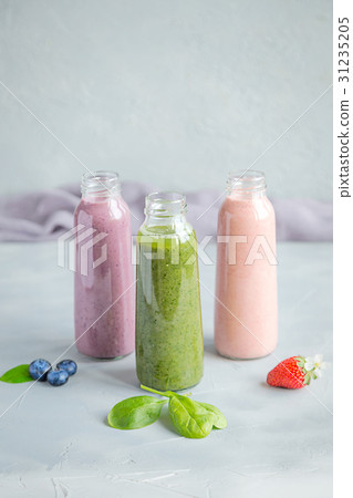 Variaty of Smoothie in bottles Grey background Variaty of Smoothie in bottles Grey background 31235205