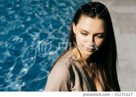 Hot woman relax near swimming pool,toned skin Hot woman relax near swimming pool,toned skin 31235227