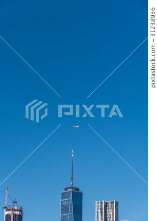 An airplane flying over skyscrapers in New York / Manhattan An airplane flying over skyscrapers in New York / Manhattan 31238936