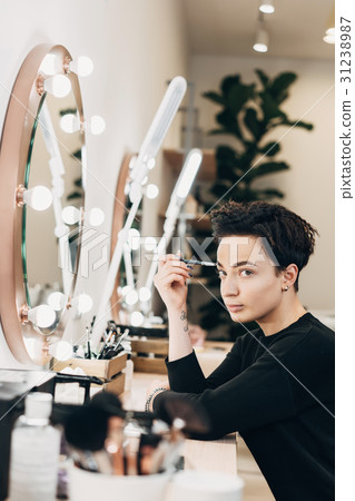 Attractive woman at the mirror in beauty studio Attractive woman at the mirror in beauty studio 31238987