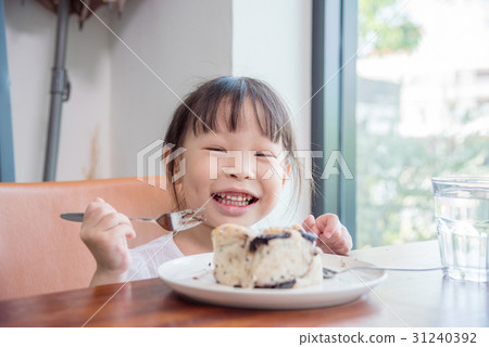 Little girl eating bread with chocolate at home Little girl eating bread with chocolate at home 31240392