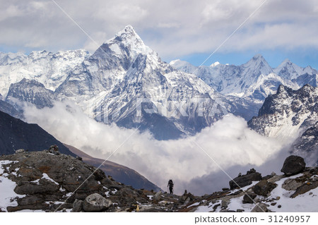 Ama Dablam mountain, sky, clouds, and hiker. 31240957