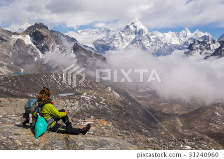 Young Woman hiker sitting and looks on Ama Dablam 31240960