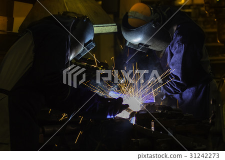 Team welders are welding car part in factory Team welders are welding car part in factory 31242273
