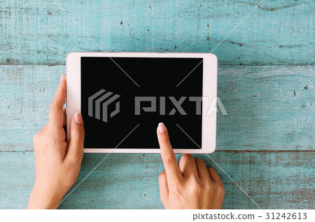 Woman hands using tablet with blank screen. 31242613