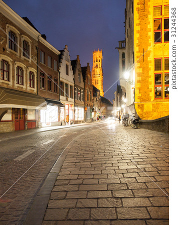 Bruges by night. Cobbled street and illuminated 31244368