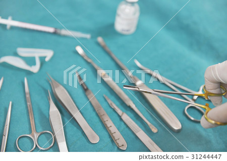 Hand holding surgical instruments  31244447