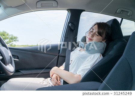 A woman sleeping in the driver's seat 31245249