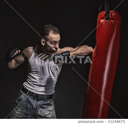 Boxing kick in the red punching pear 31248673