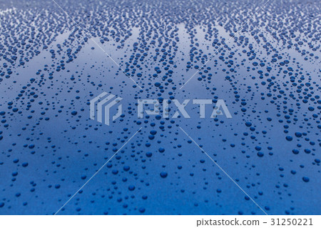 Drops of rain on a blue shiny smooth surface. 31250221