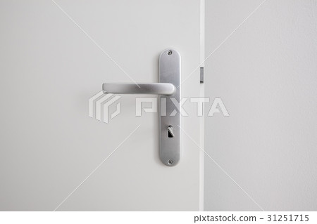metal door handle with key on white door 31251715