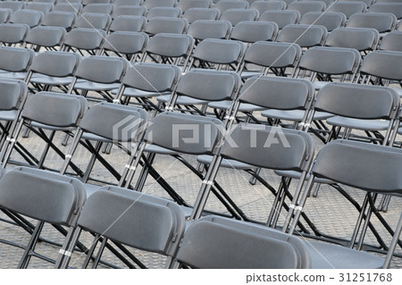 many empty black folding chair rows 31251768