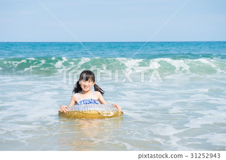 A girl swimming in the sea 31252943