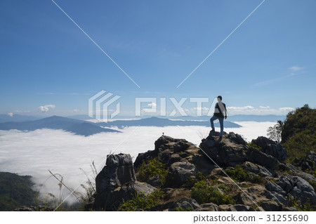 man standing on the cliff at the mountains 31255690