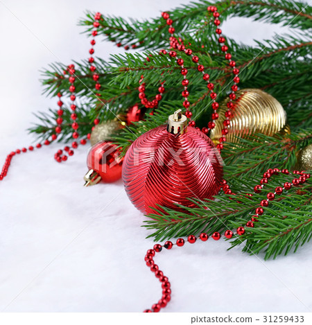 Christmas balls and garland on a spruce branch Christmas balls and garland on a spruce branch 31259433