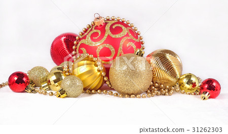 Golden and red Christmas decorations on a white Golden and red Christmas decorations on a white 31262303