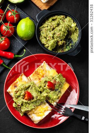 Mexican chimichanga with guacamole dip 31262438