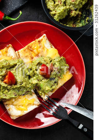 Mexican chimichanga with guacamole dip 31262439
