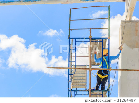 Construction workers working on scaffolding 31264497