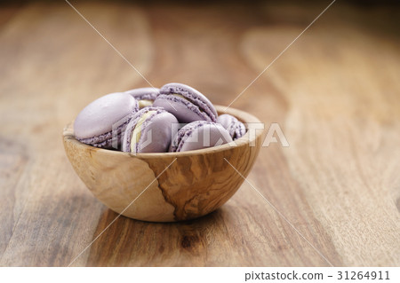 violet macarons in wood bowl on wooden table violet macarons in wood bowl on wooden table 31264911