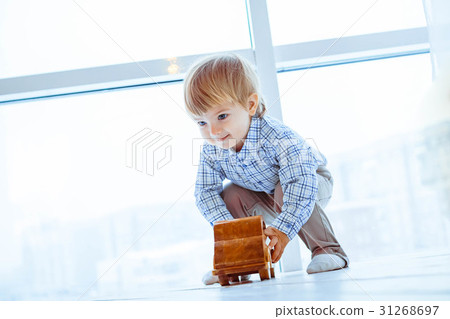 Boy rolls a toy car Boy rolls a toy car 31268697