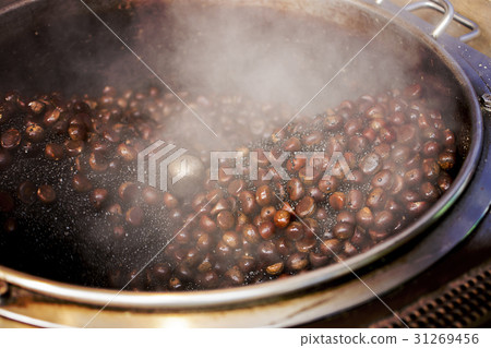 Roasted chestnuts in a hot pan. Roasted chestnuts in a hot pan. 31269456