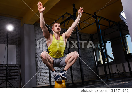 Young athletic man doing exercises in cross fit Young athletic man doing exercises in cross fit 31271992