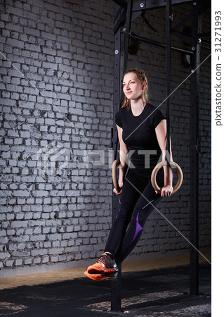 Young athletic woman doing pull-ups exercise with 31271993