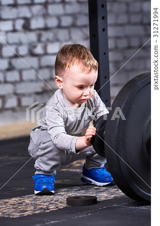 Little sporty boy in the grey sportwear looking 31271994