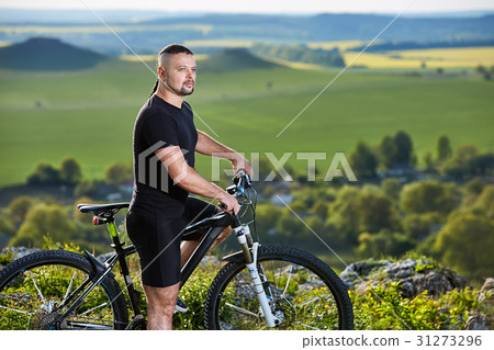 Close-up portrait of the mountain biker looking at 31273296