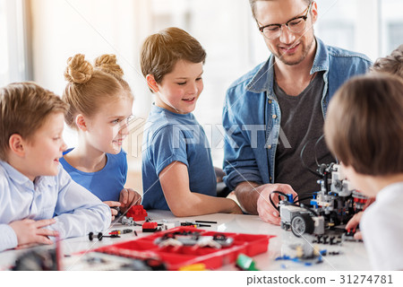 Happy smiling team of constructors in workshop Happy smiling team of constructors in workshop 31274781