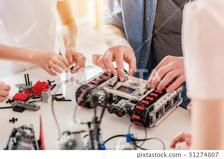 Busy technical team working on toy Busy technical team working on toy 31274807