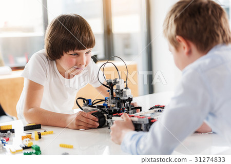 Confident boys happily using robotics for play 31274833