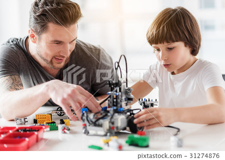 Happy smiling teacher helping pupil 31274876