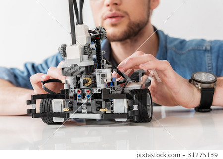 Busy man checking spare parts of toy Busy man checking spare parts of toy 31275139