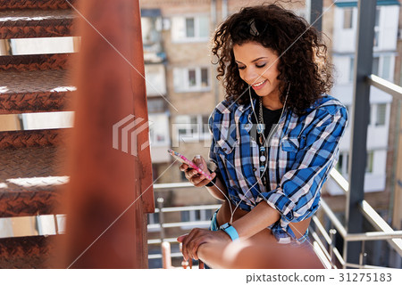 Pretty mulatto girl listening to music from Pretty mulatto girl listening to music from 31275183