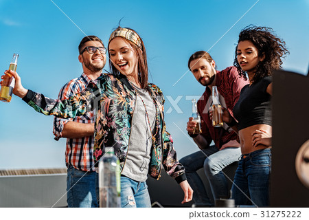 Happy friends having party on building roof Happy friends having party on building roof 31275222